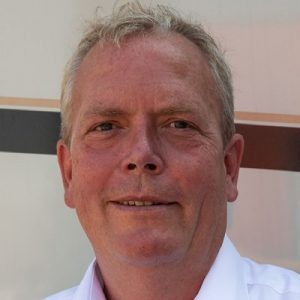 Dirk Schaper, Geschäftsführer, mit einem neutralen Gesichtsausdruck vor einem hellen Hintergrund.